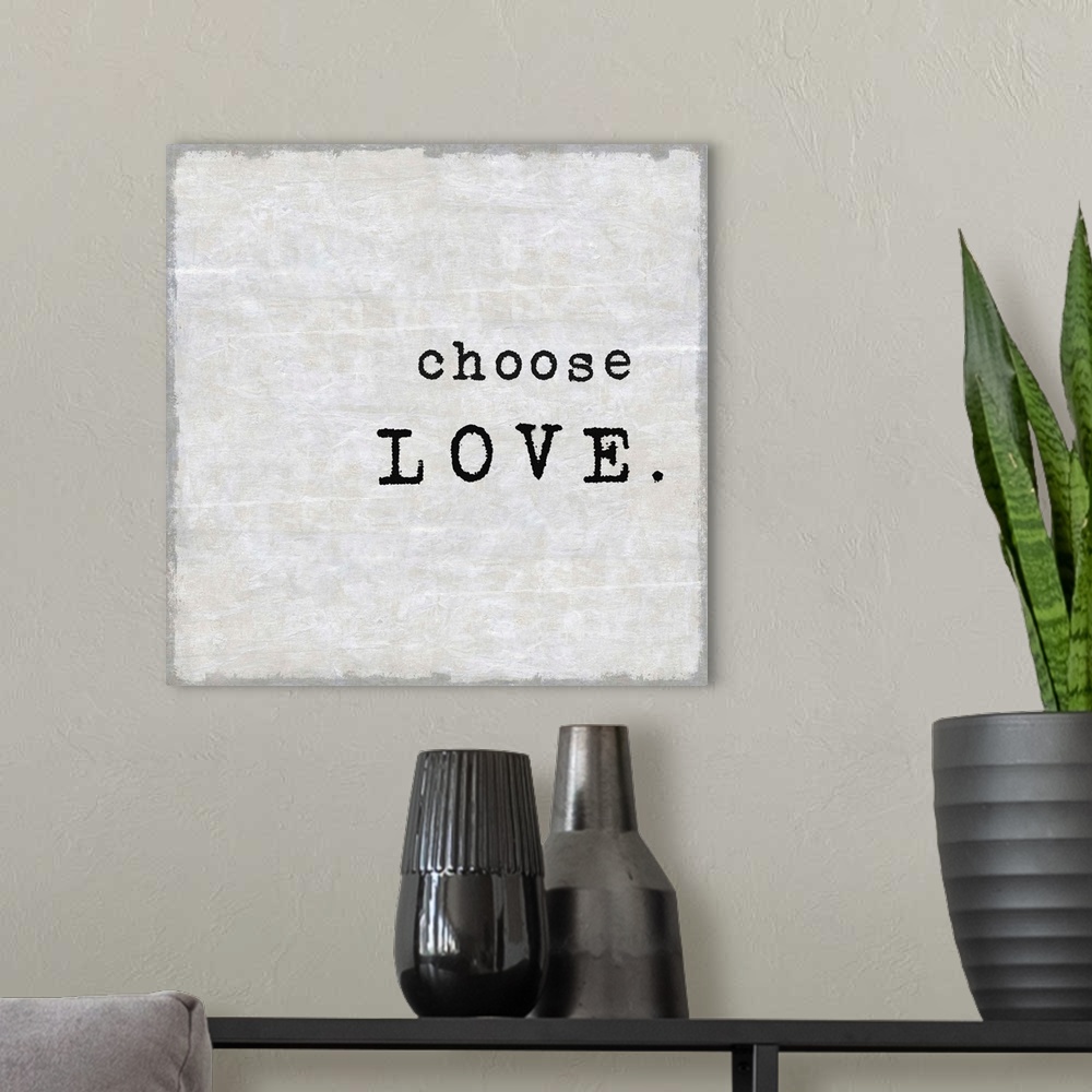 A modern room featuring "Choose Love" on a square background in shades of gray.