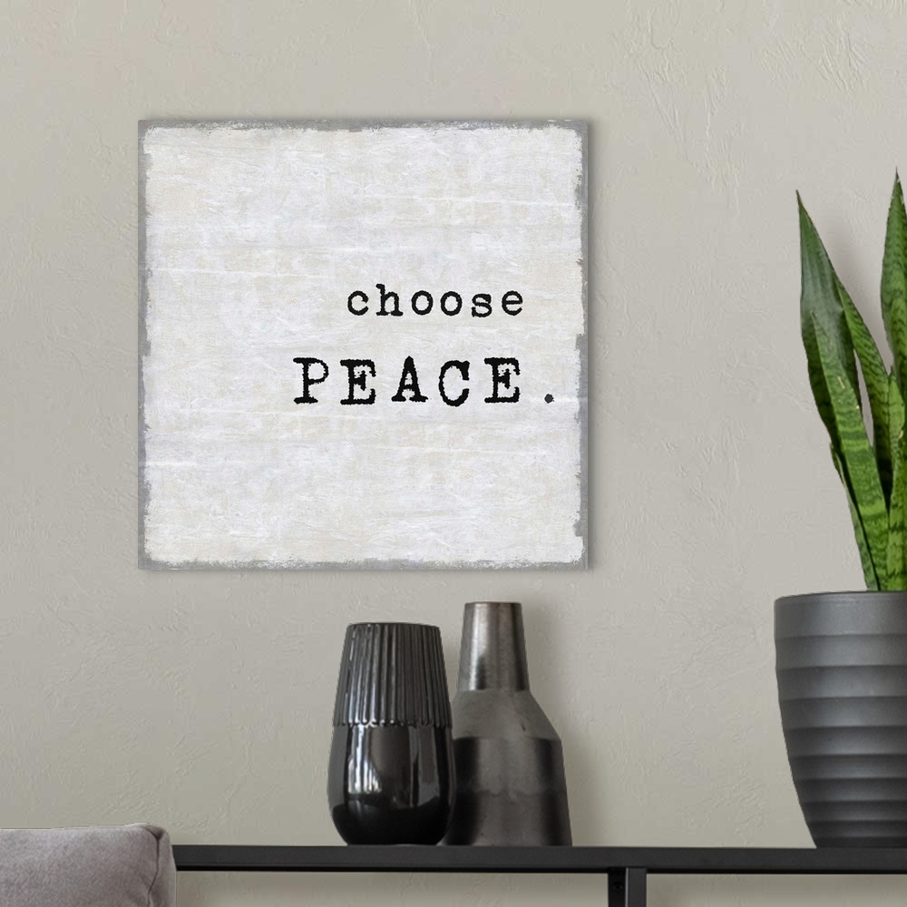 A modern room featuring "Choose Peace" on a square background in shades of gray.