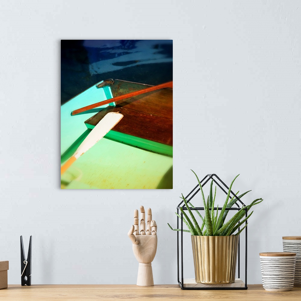 A bohemian room featuring Photograph of a colorful boat and an oar with an interesting composition.