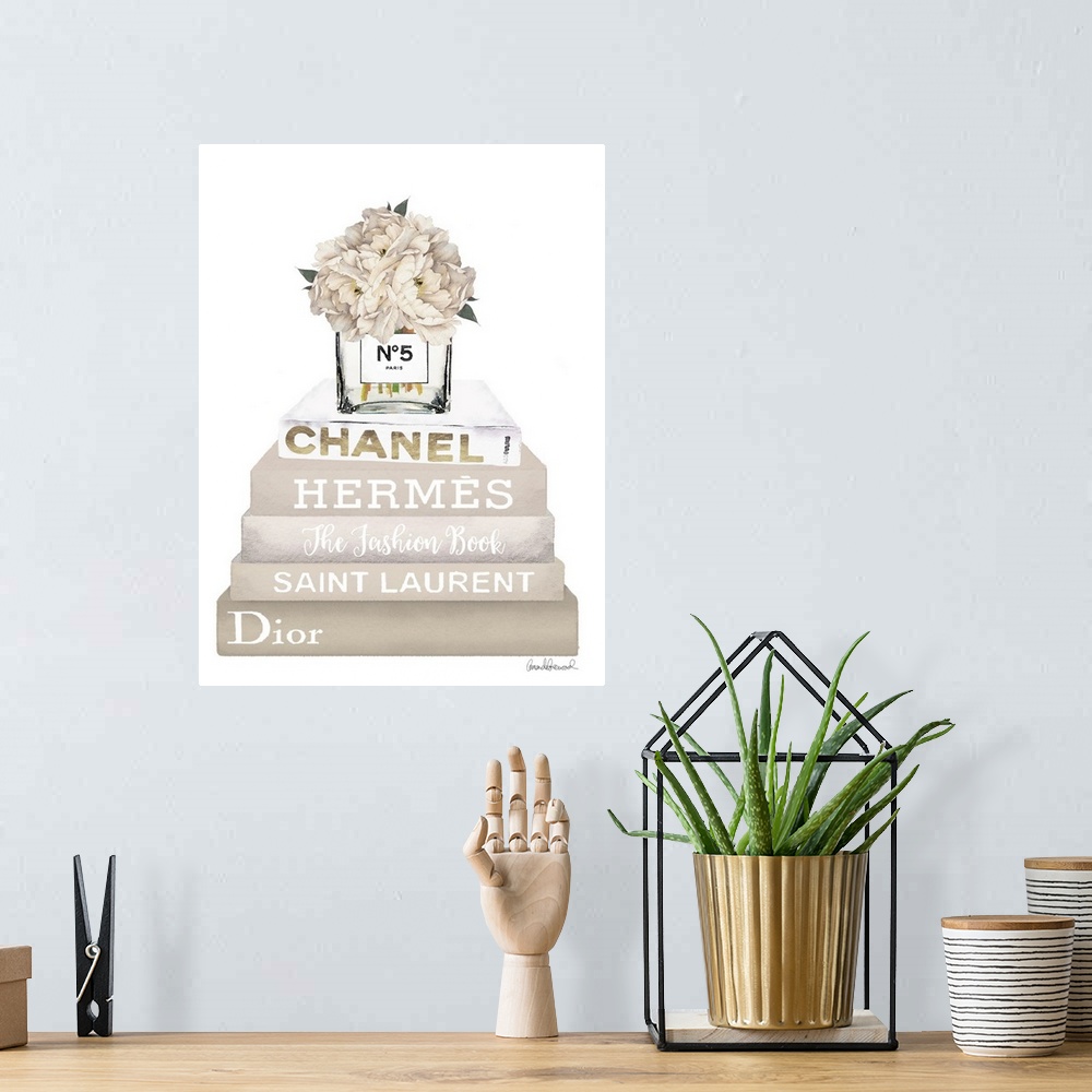 A bohemian room featuring A bouquet of flowers sit atop a stack of designer books.