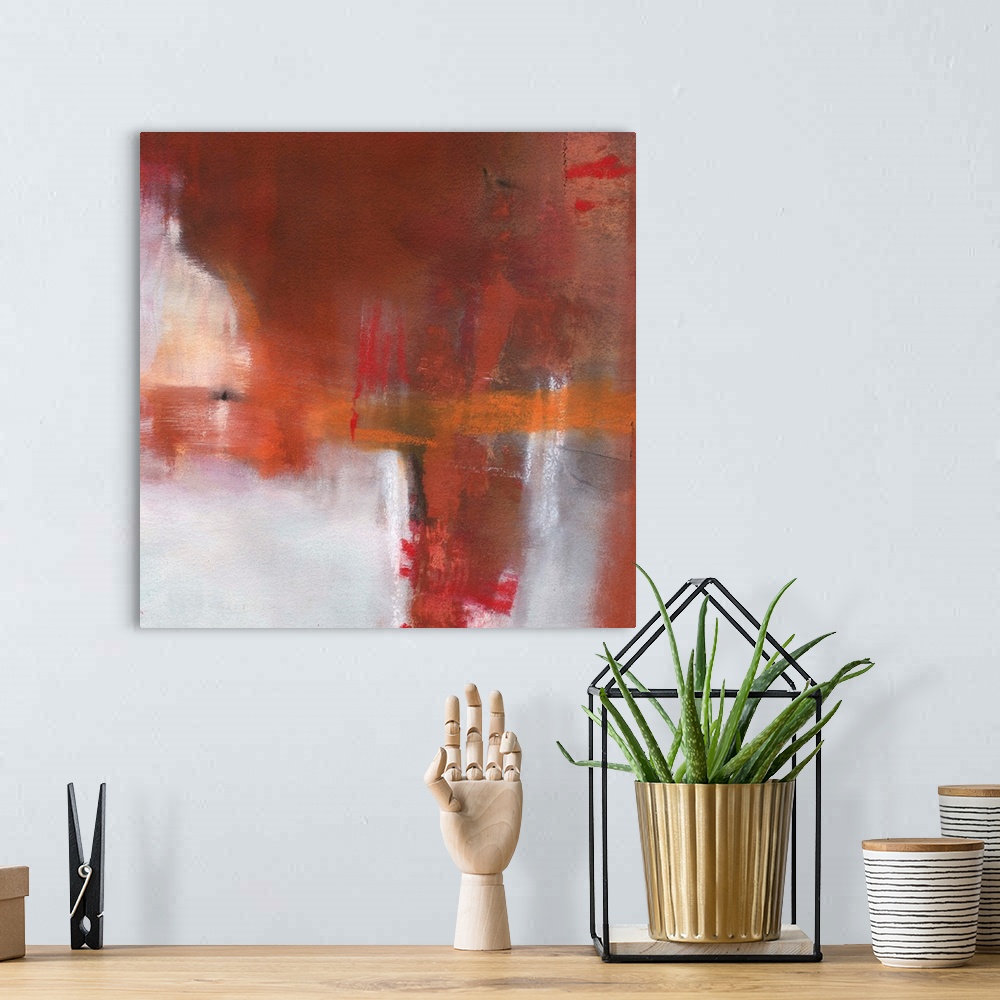 A bohemian room featuring Square abstract painting with deep red, burnt orange, orange, white, and black hues.