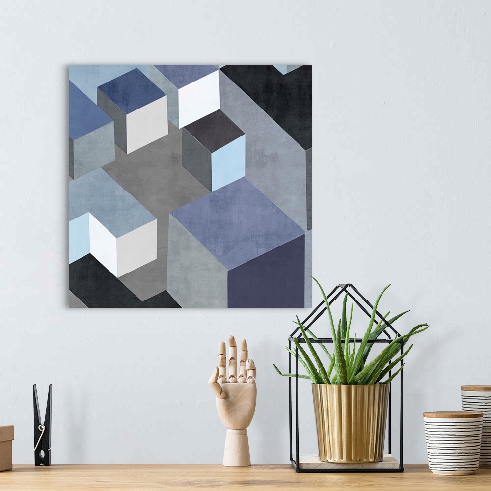 A bohemian room featuring Abstract square art created with black, white, silver, and blue squares creating 3D looking cubes...