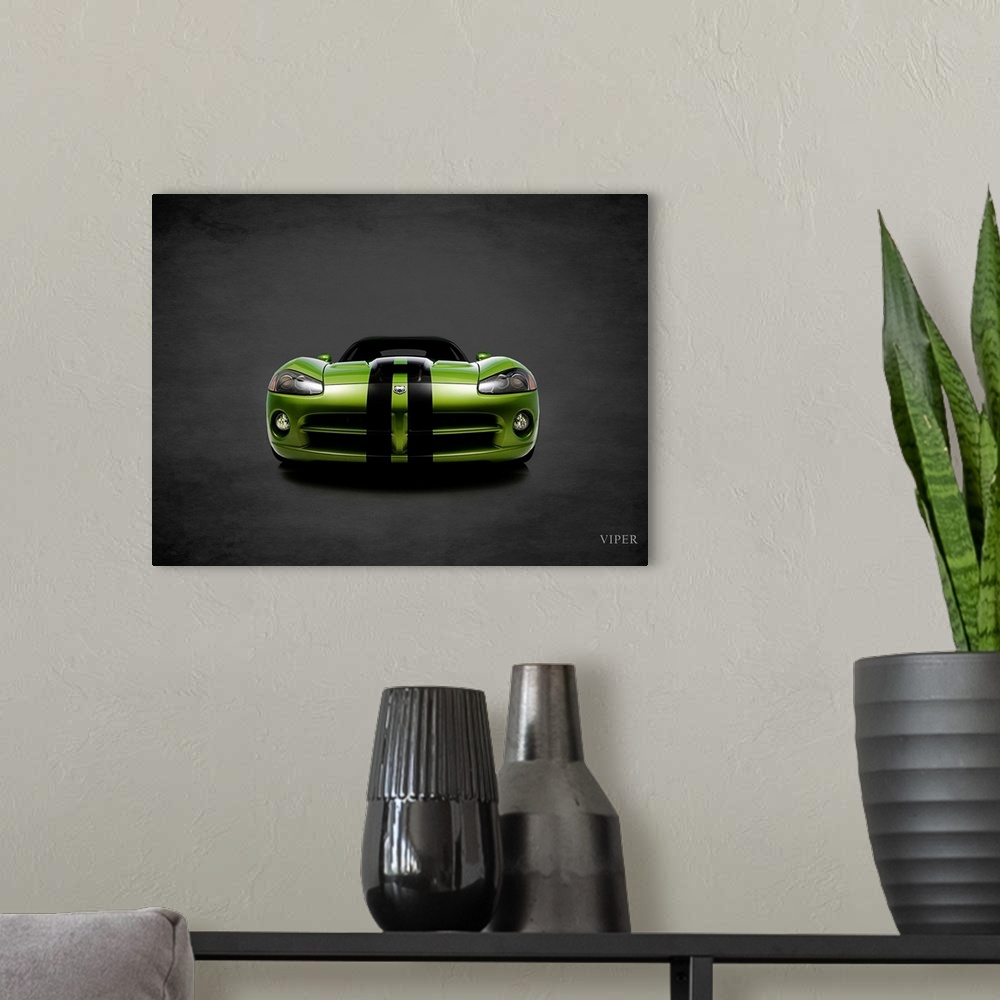 A modern room featuring Photograph of a green Dodge Viper with black stripes printed on a black background with a dark vi...
