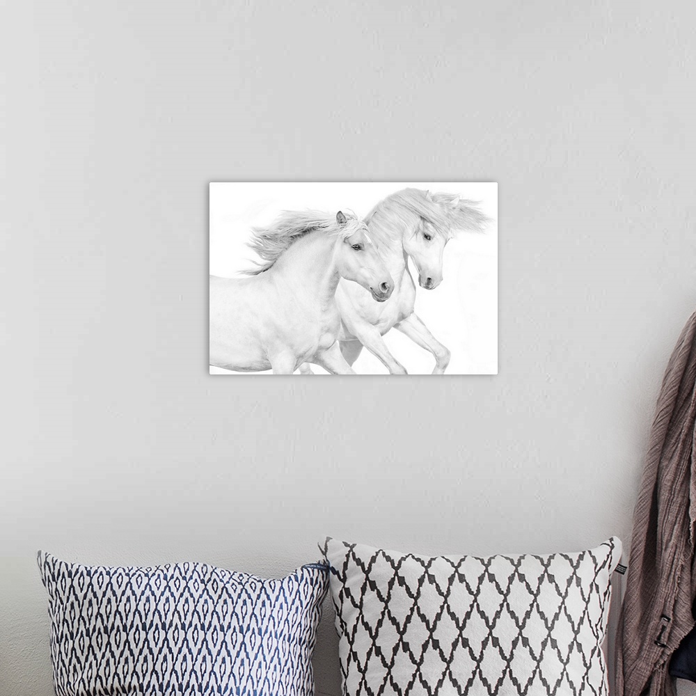 A bohemian room featuring Photograph of galloping white horses against a white background.