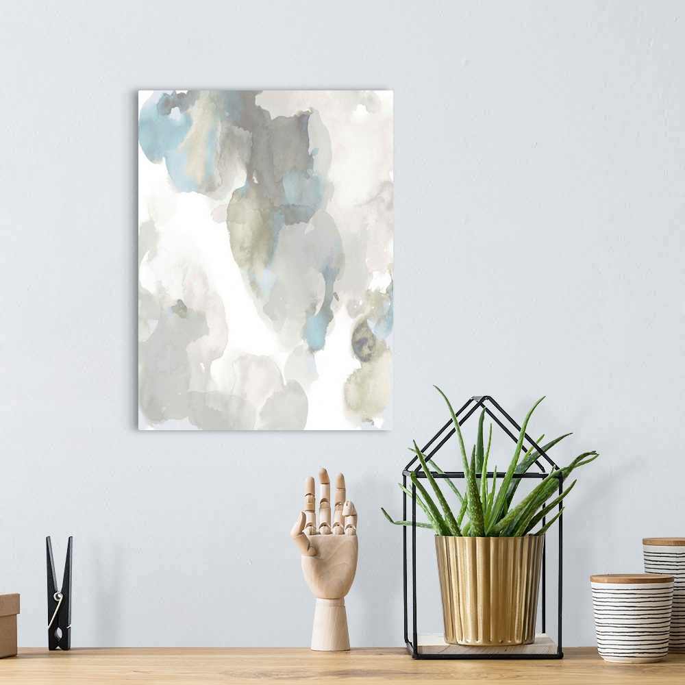 A bohemian room featuring Abstract painting with light blue and gray hues splattered together on a white background.