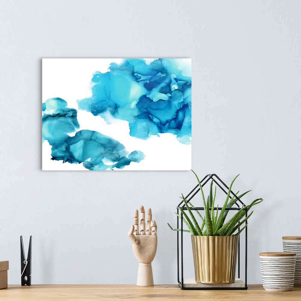 A bohemian room featuring Abstract painting with aqua hues splattered together on a white background.