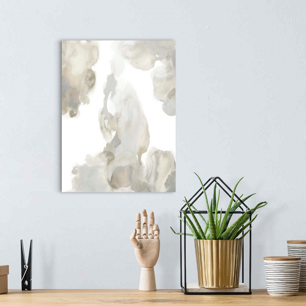 A bohemian room featuring Abstract painting with tan and gray hues splattered together on a white background.