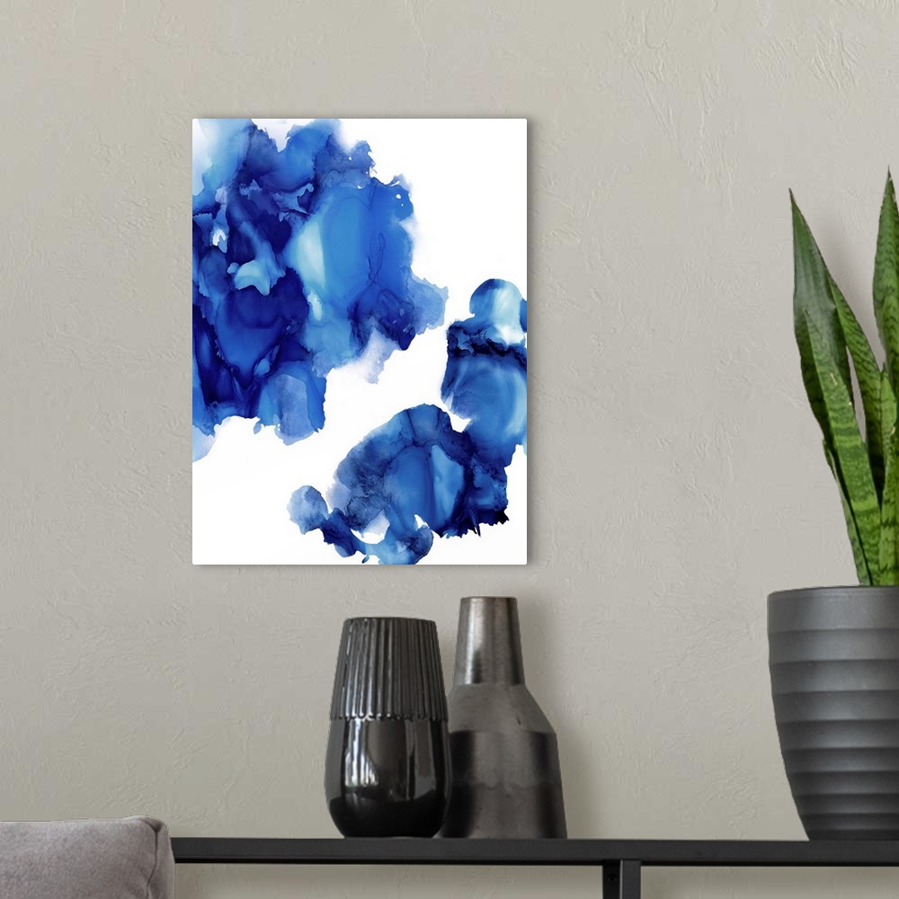 A modern room featuring Abstract painting with indigo hues splattered together on a white background.