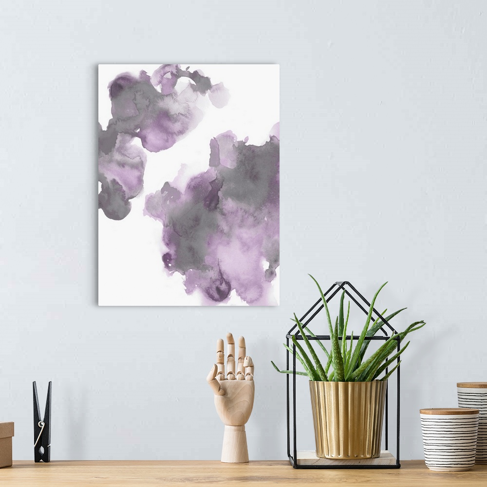 A bohemian room featuring Abstract painting with lavender and gray hues splattered together on a white background.