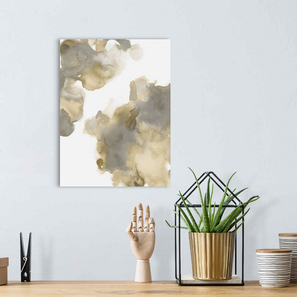 A bohemian room featuring Abstract painting with gold and gray hues splattered together on a white background.