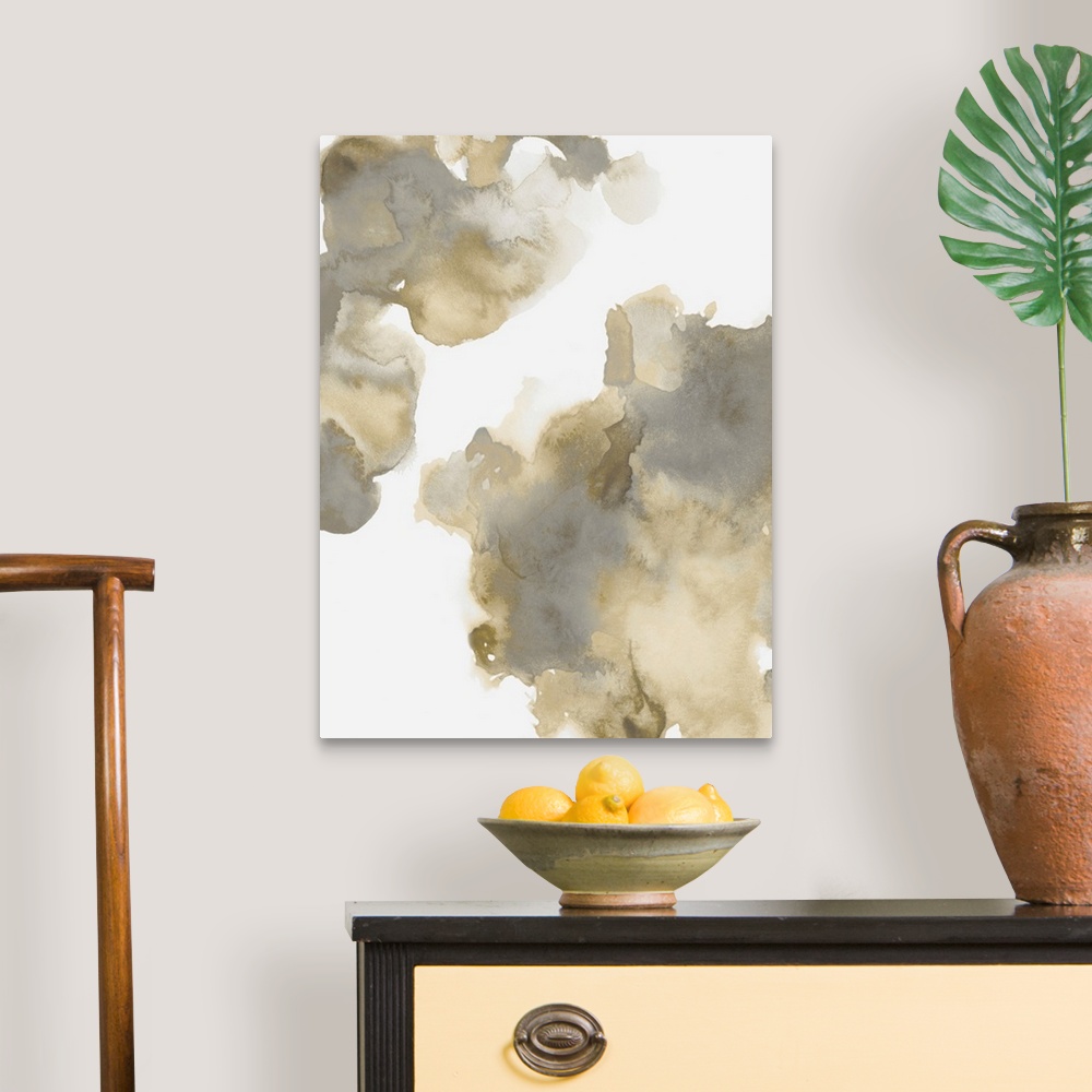 A traditional room featuring Abstract painting with gold and gray hues splattered together on a white background.