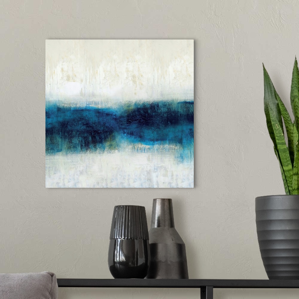 A modern room featuring Square abstract art made with shades of blue and neutral hues.