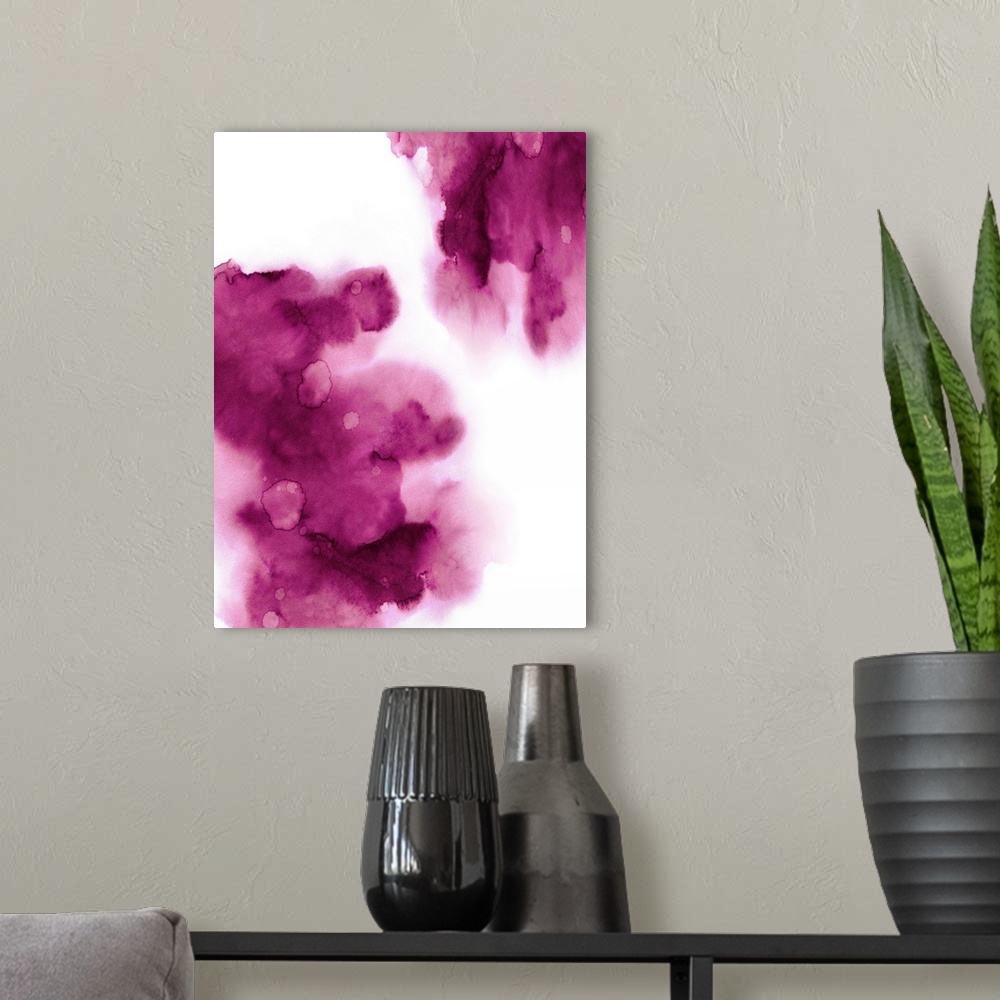 A modern room featuring Abstract painting with fuchsia hues splattered together on a white background.