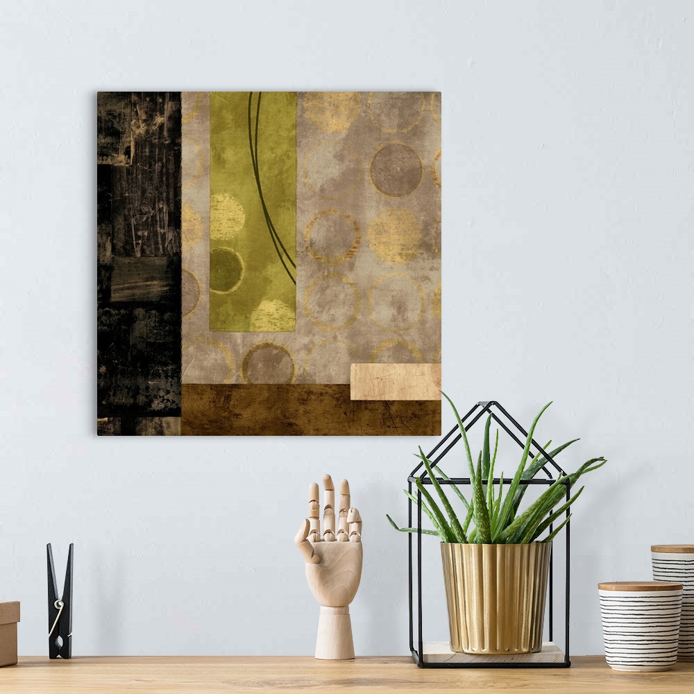 A bohemian room featuring Square abstract with black, gold, cream, and olive green rectangles and metallic gold circles,