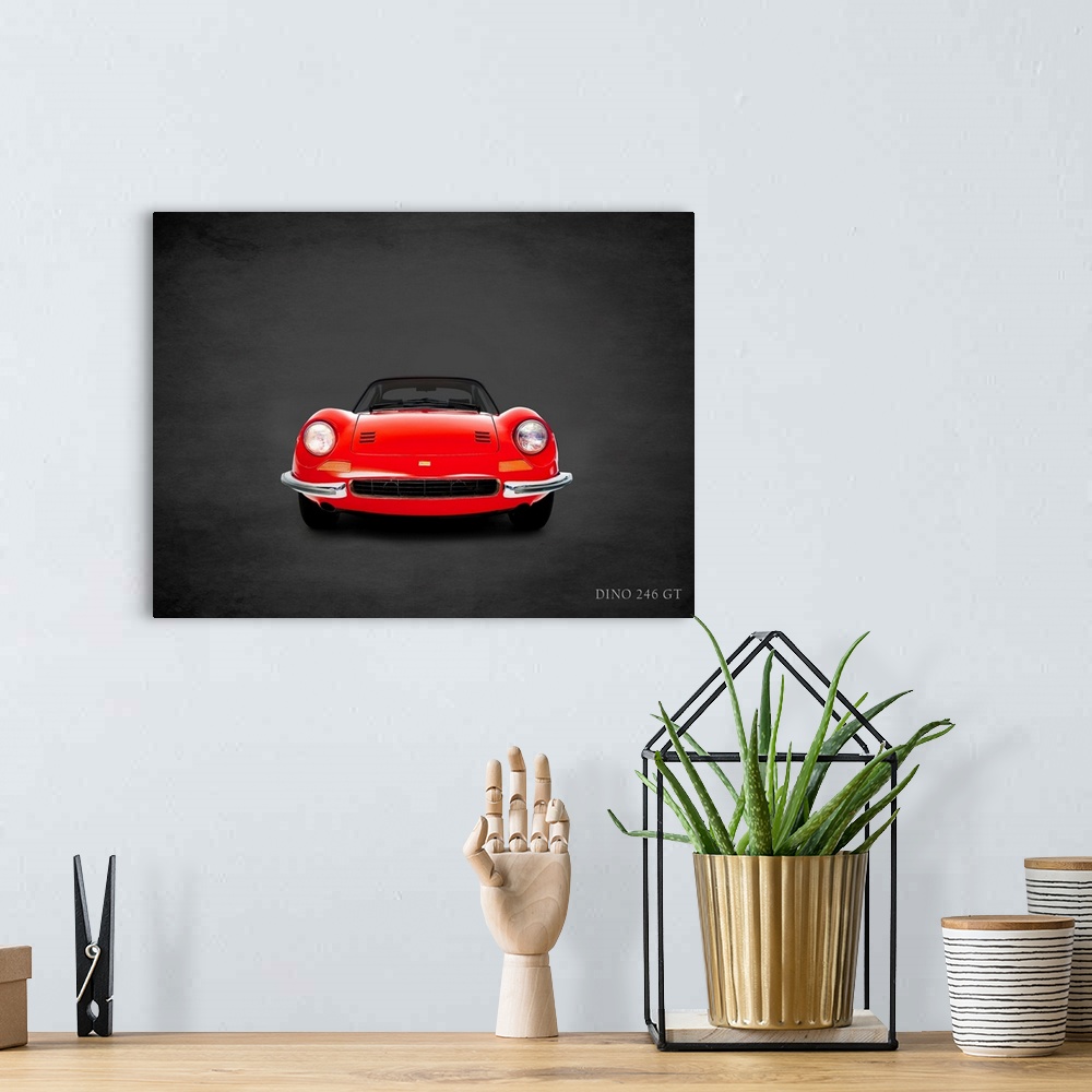 A bohemian room featuring Photograph of a red 1969 Ferrari Dino 246GT printed on a black background with a dark vignette.