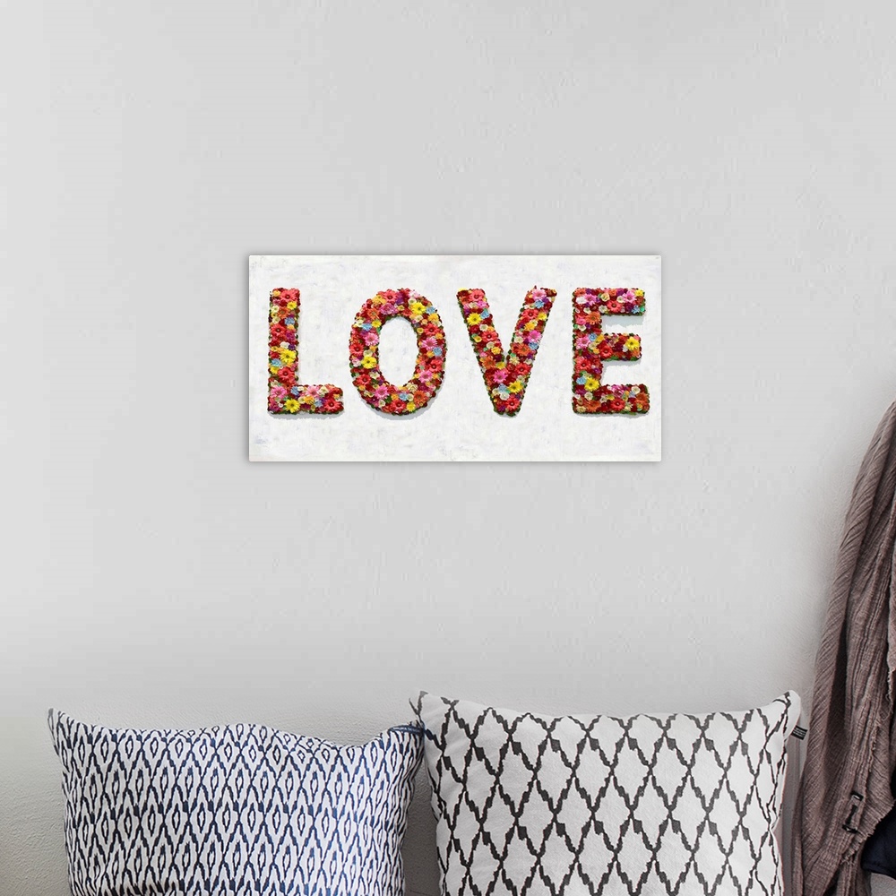 A bohemian room featuring The word love is shaped by an assortment of colorful flowers.