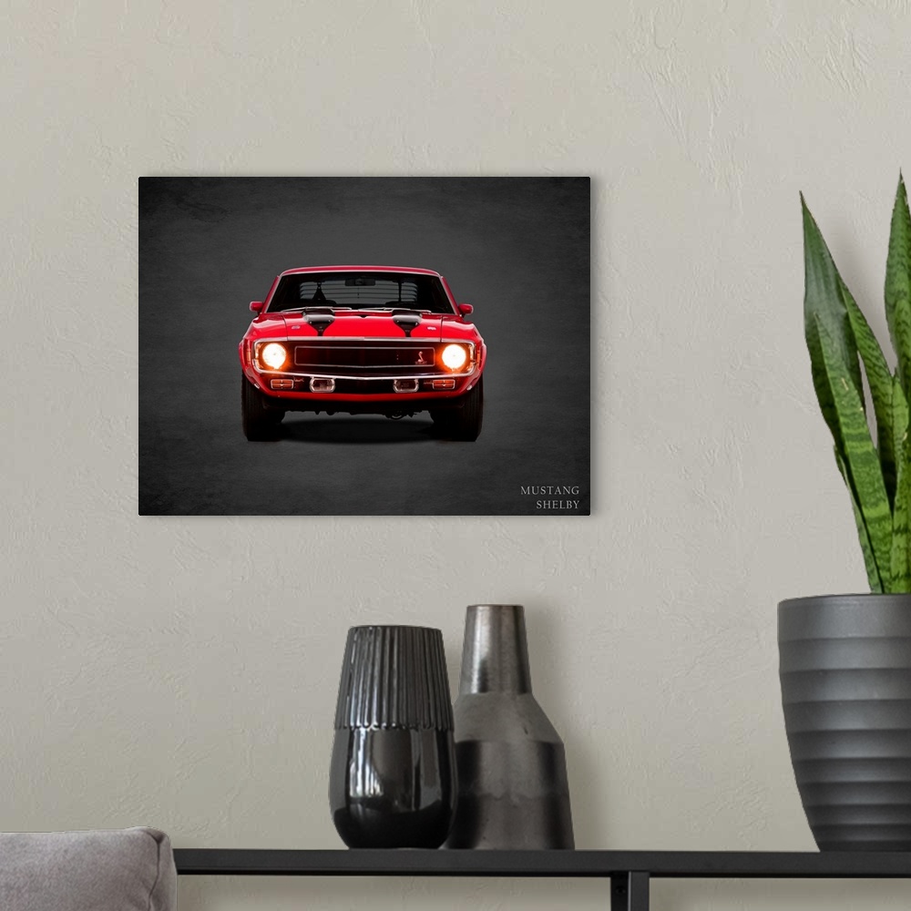 A modern room featuring Photograph of a red 1970 Ford Mustang Shelby with black stripes printed on a black background wit...