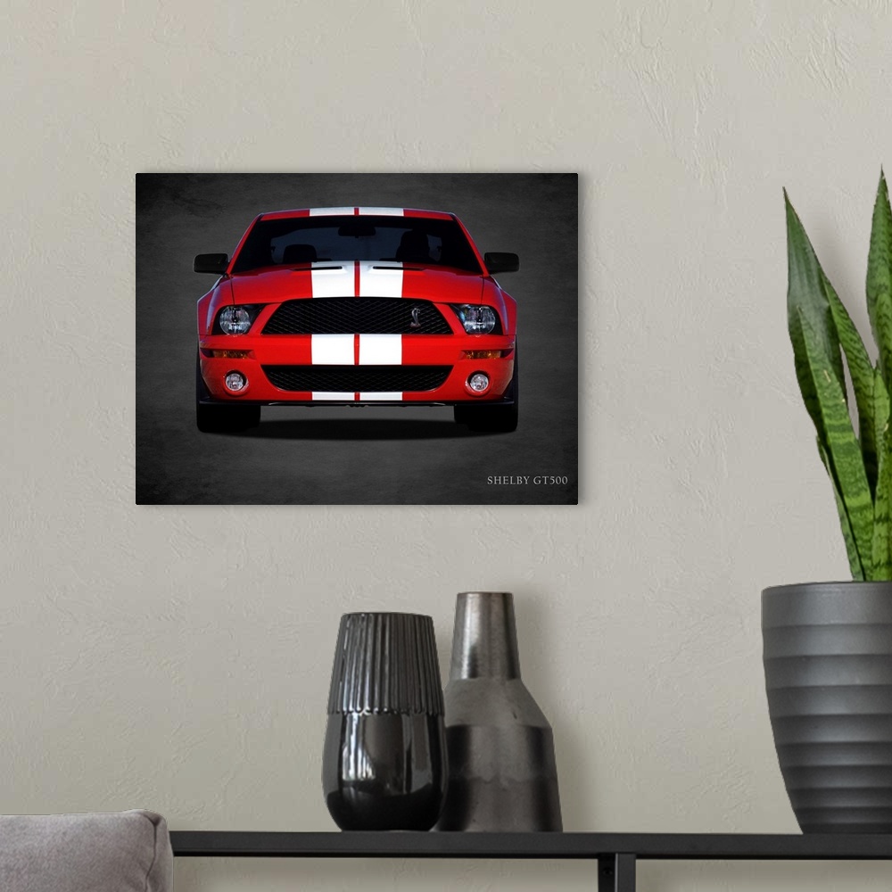 A modern room featuring Photograph of a red Ford Shelby GT500 with white stripes printed on a black background with a dar...