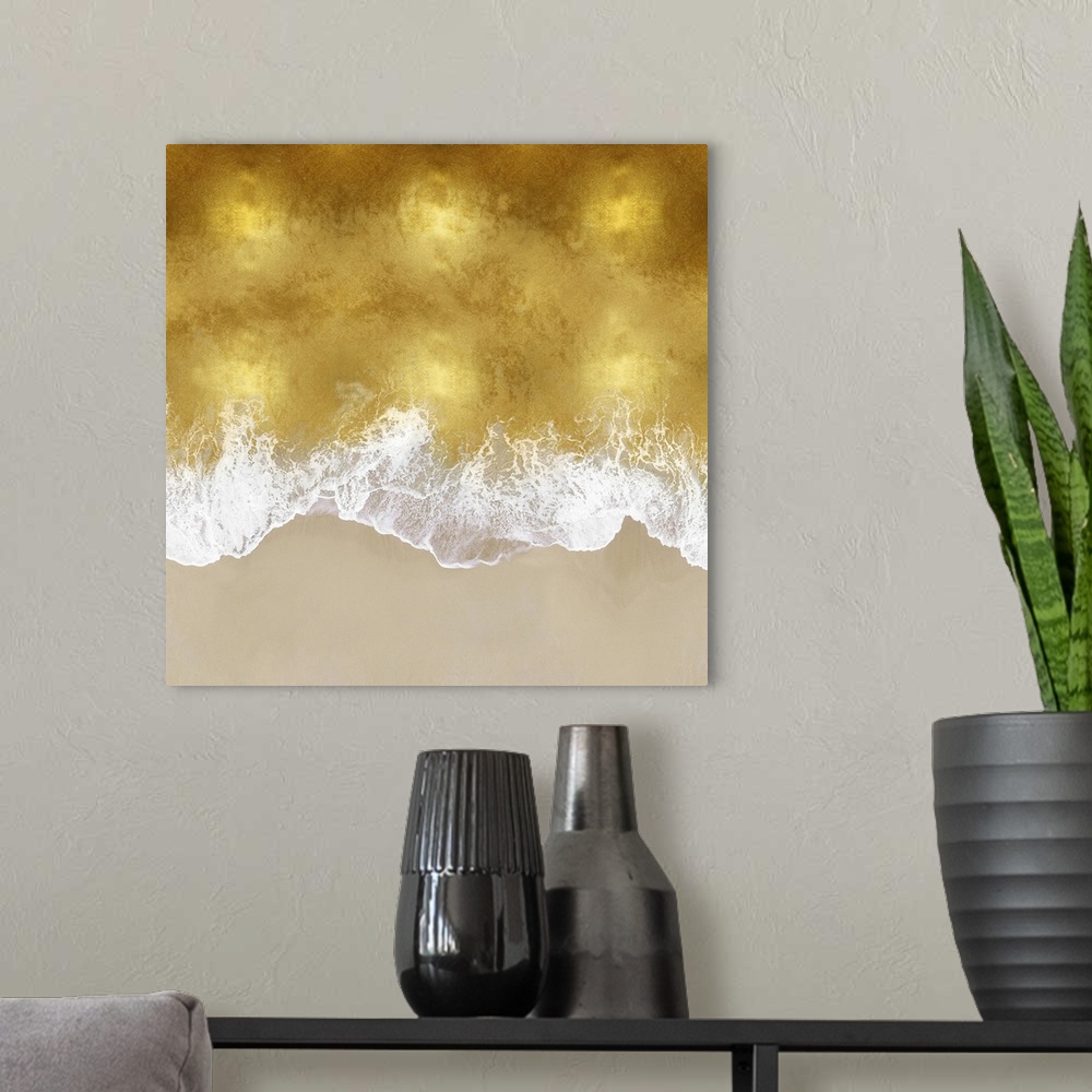 A modern room featuring One artwork in a series of aerial shots of a beach as gold waves break upon the shore.