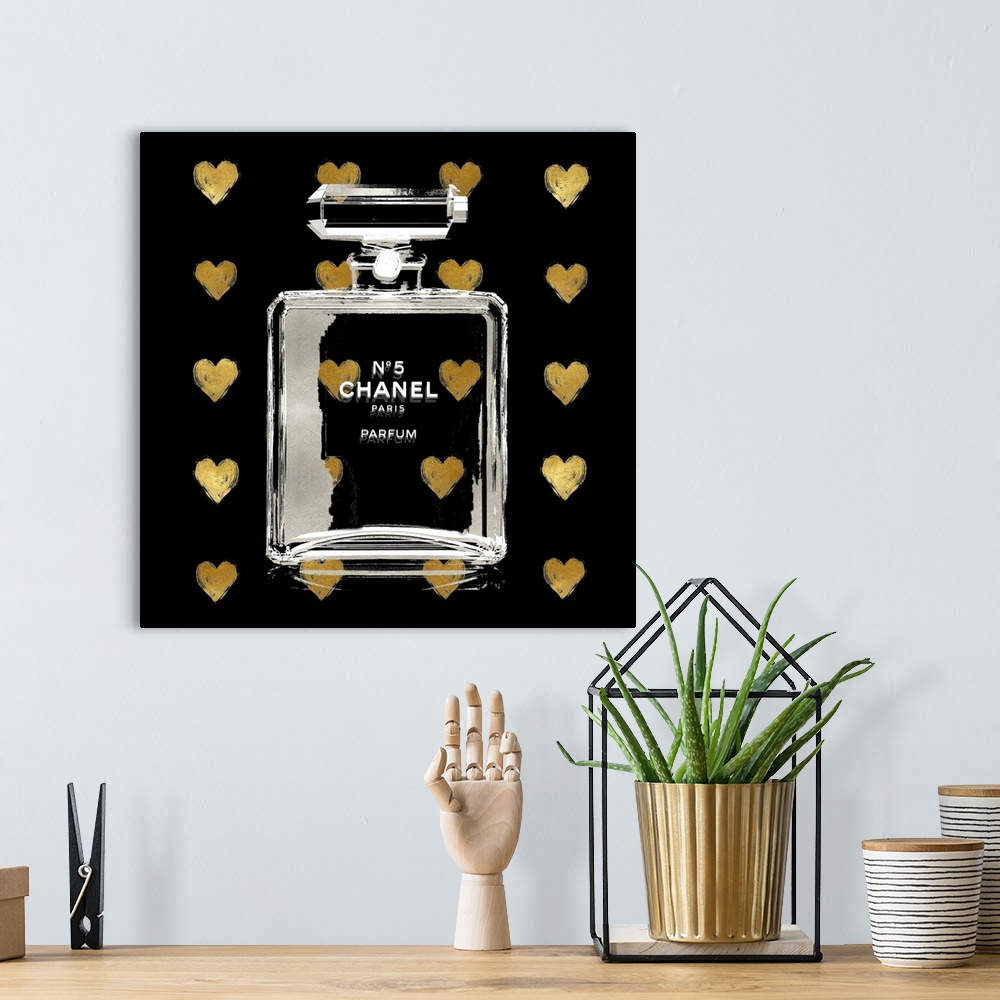 A bohemian room featuring A black background with hearts peek through a transparent bottle of perfume.