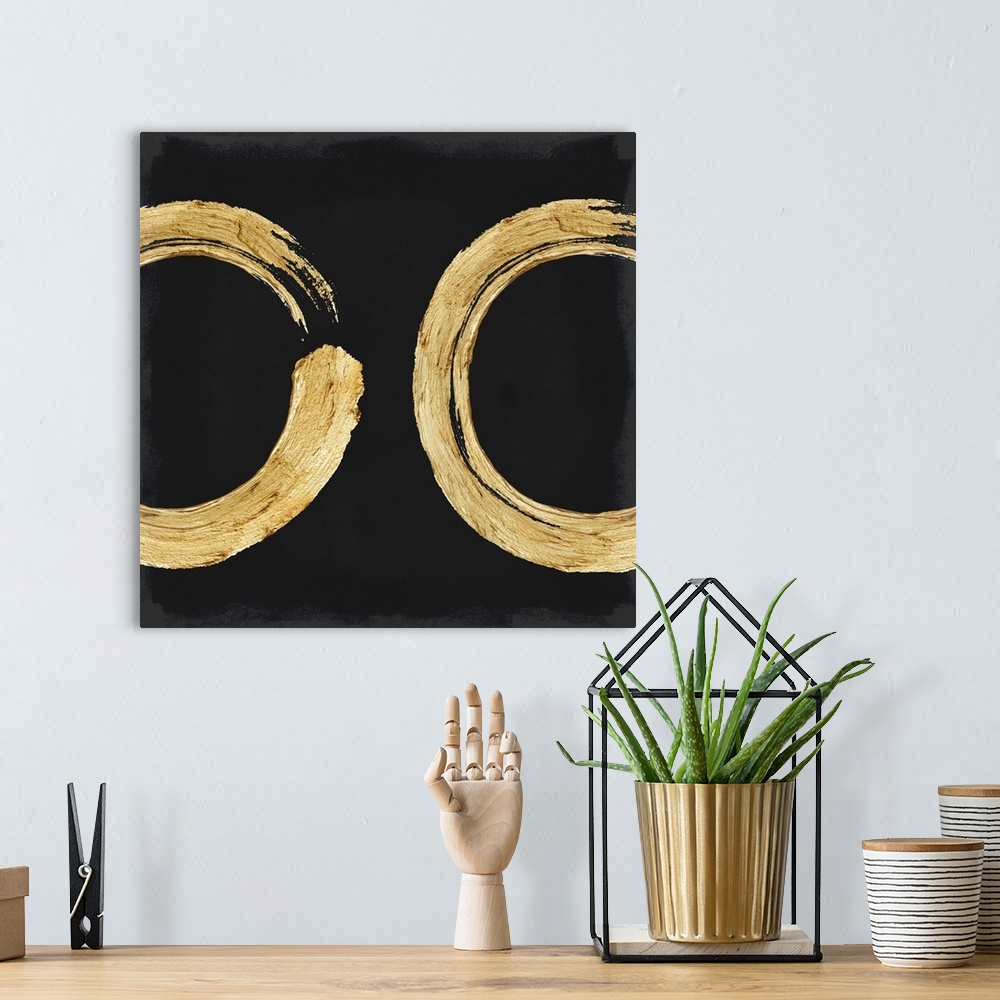 A bohemian room featuring This Zen artwork features two sweeping circular brush strokes in gold over a black background wit...