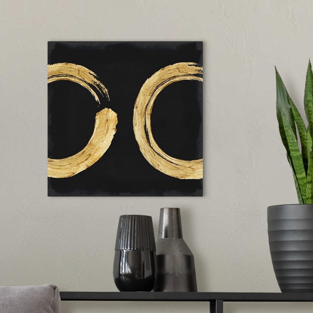 A modern room featuring This Zen artwork features two sweeping circular brush strokes in gold over a black background wit...