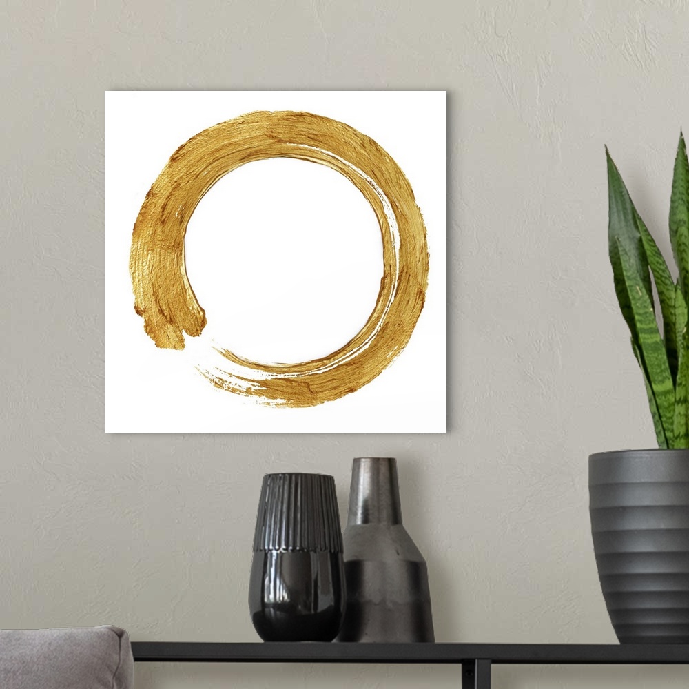 A modern room featuring This Zen artwork features a sweeping circular brush stroke in gold over a white background.