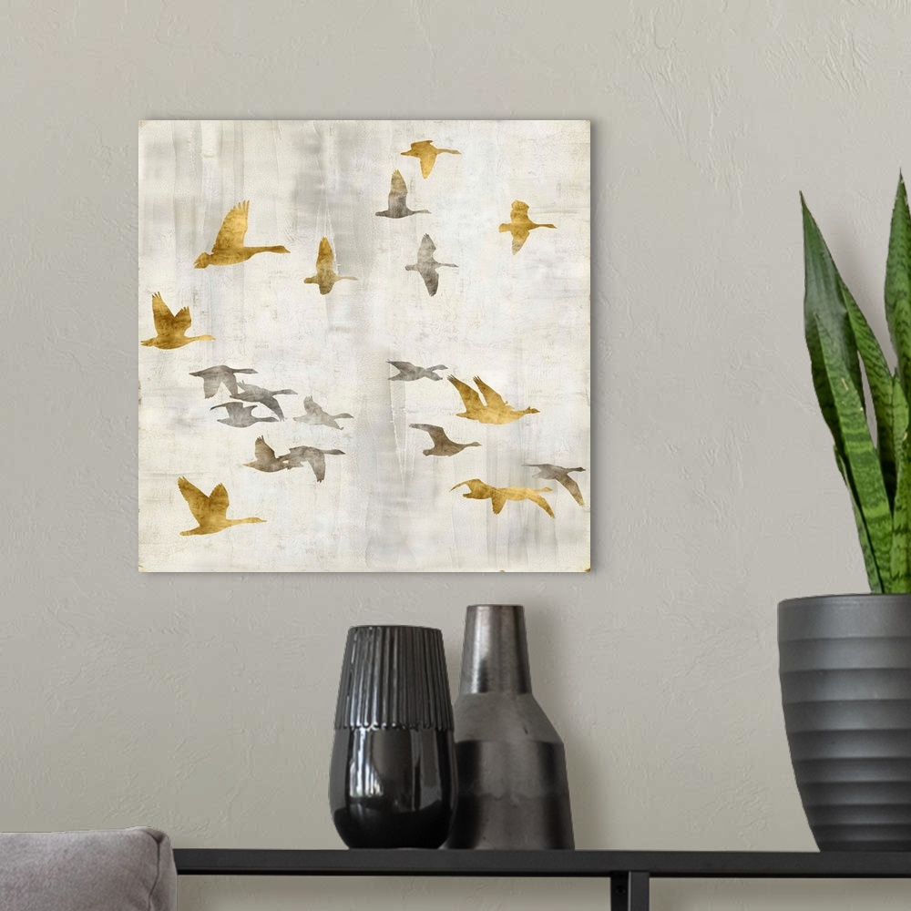 A modern room featuring Square decor with gold and silver birds flying on a distressed white background with gold trim.