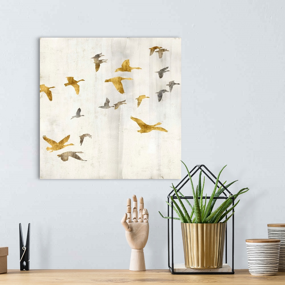 A bohemian room featuring Square decor with gold and silver birds flying on a distressed white background with gold trim.