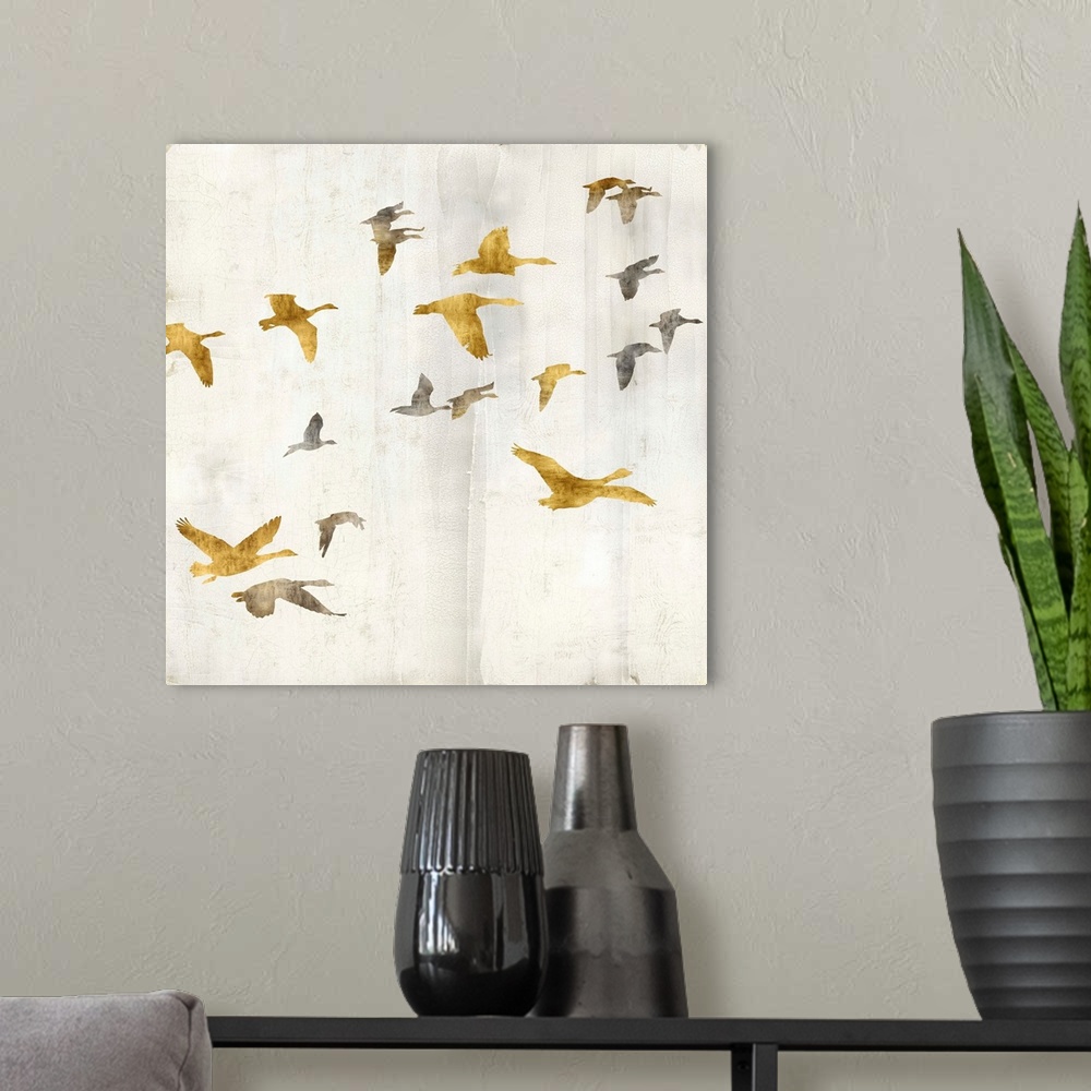 A modern room featuring Square decor with gold and silver birds flying on a distressed white background with gold trim.