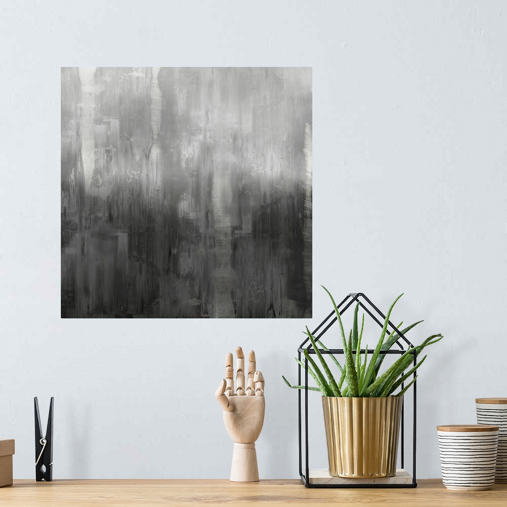 A bohemian room featuring Square abstract painting with shades of gray streaking down the canvas.