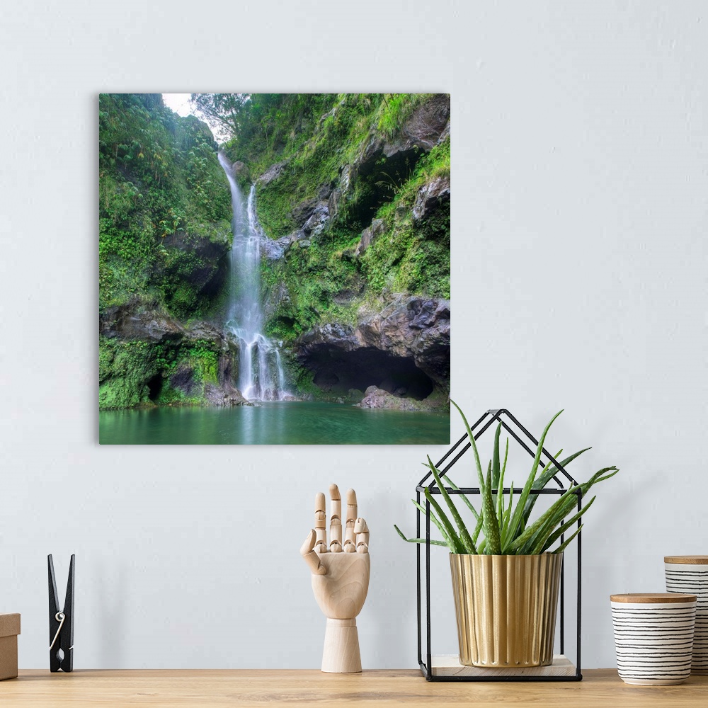 A bohemian room featuring Square photograph of a lush waterfall in Hana, Hawaii.