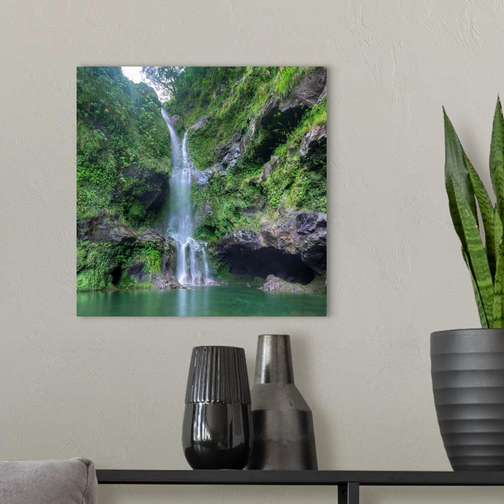 A modern room featuring Square photograph of a lush waterfall in Hana, Hawaii.