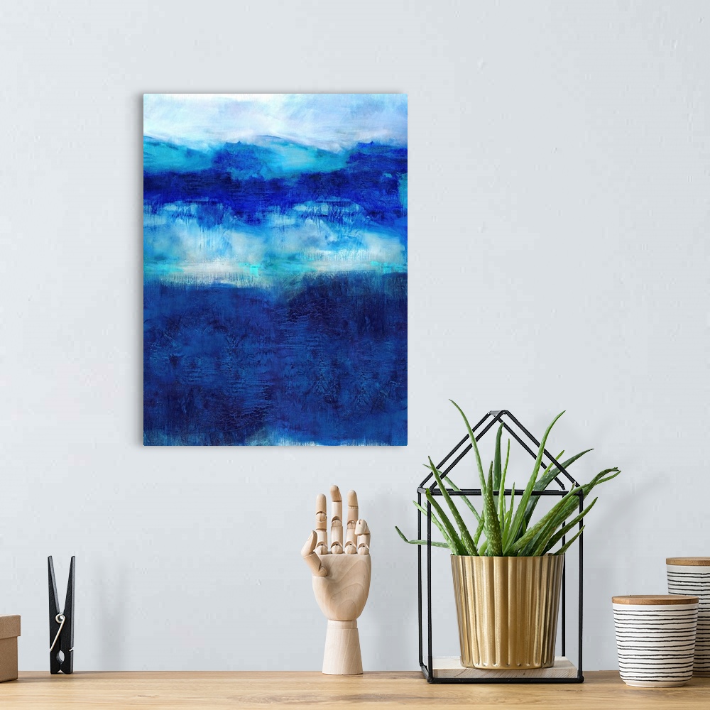A bohemian room featuring Vertical abstract painting created with deep shades of blue on a white background.