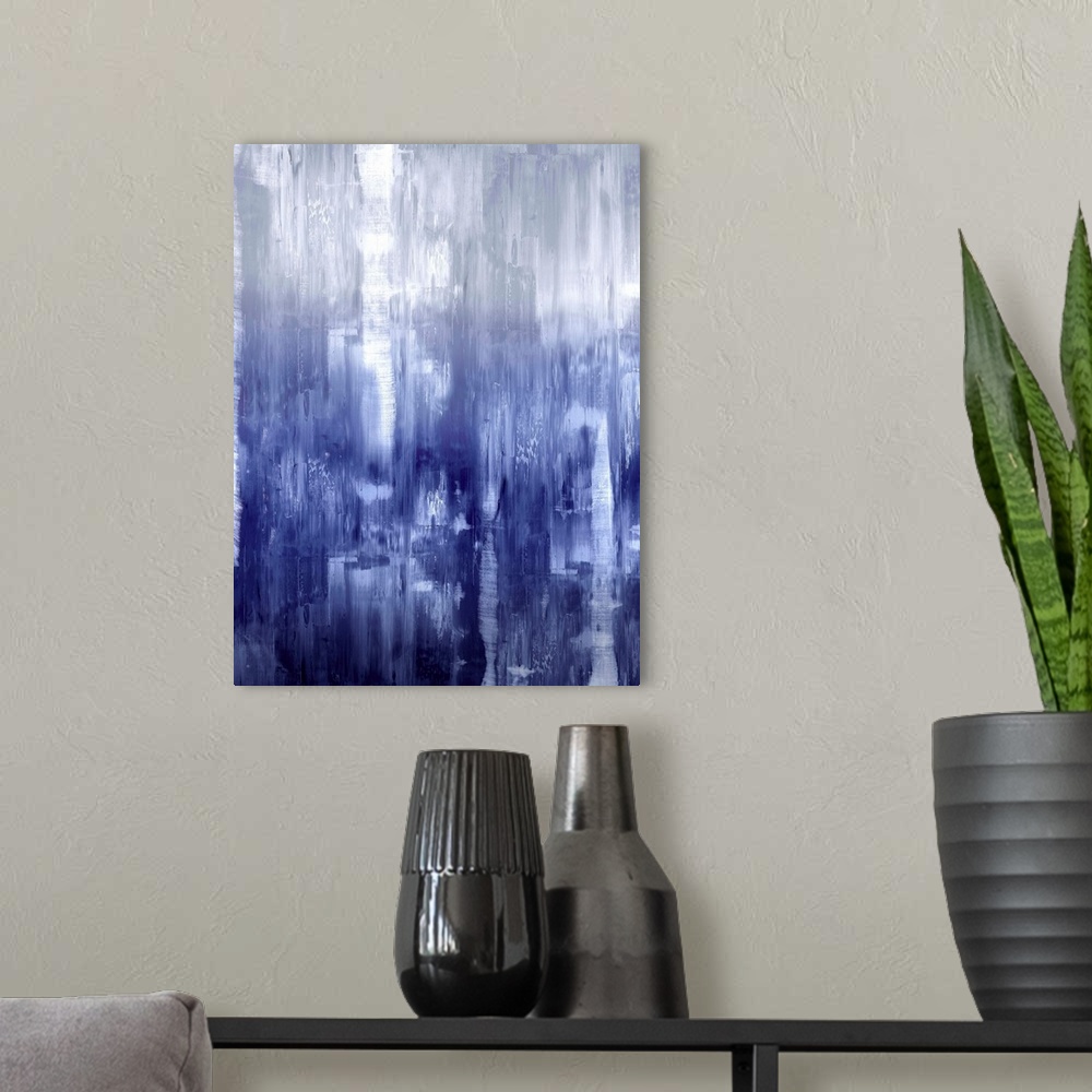 A modern room featuring Vertical abstract painting of fading shades of indigo streaking down the canvas.