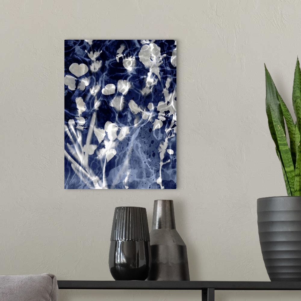 A modern room featuring Home decor with silver silhouettes of leaves and flowers on an indigo background with a watery look.