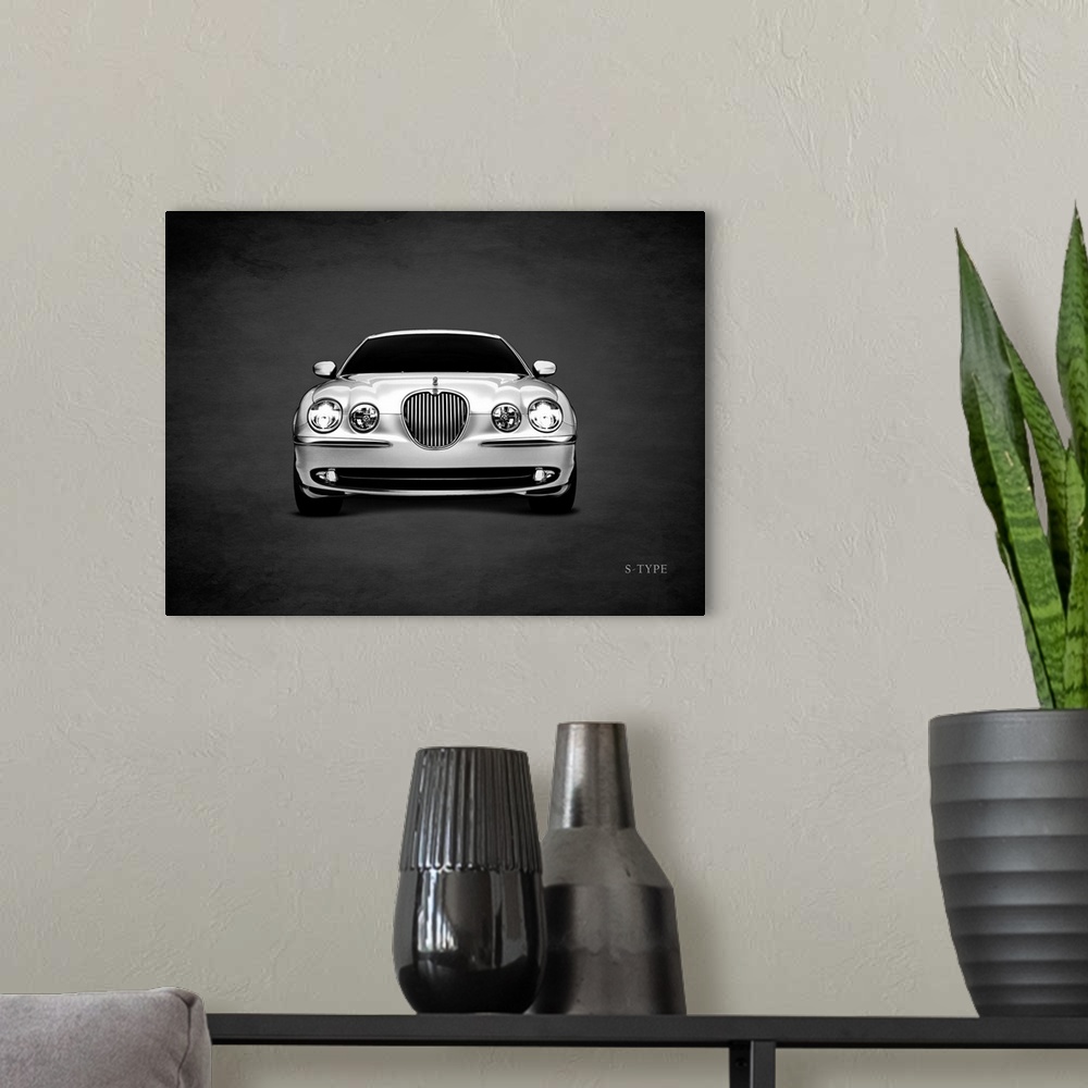 A modern room featuring Photograph of a silver Jaguar S-Type printed on a black background with a dark vignette.