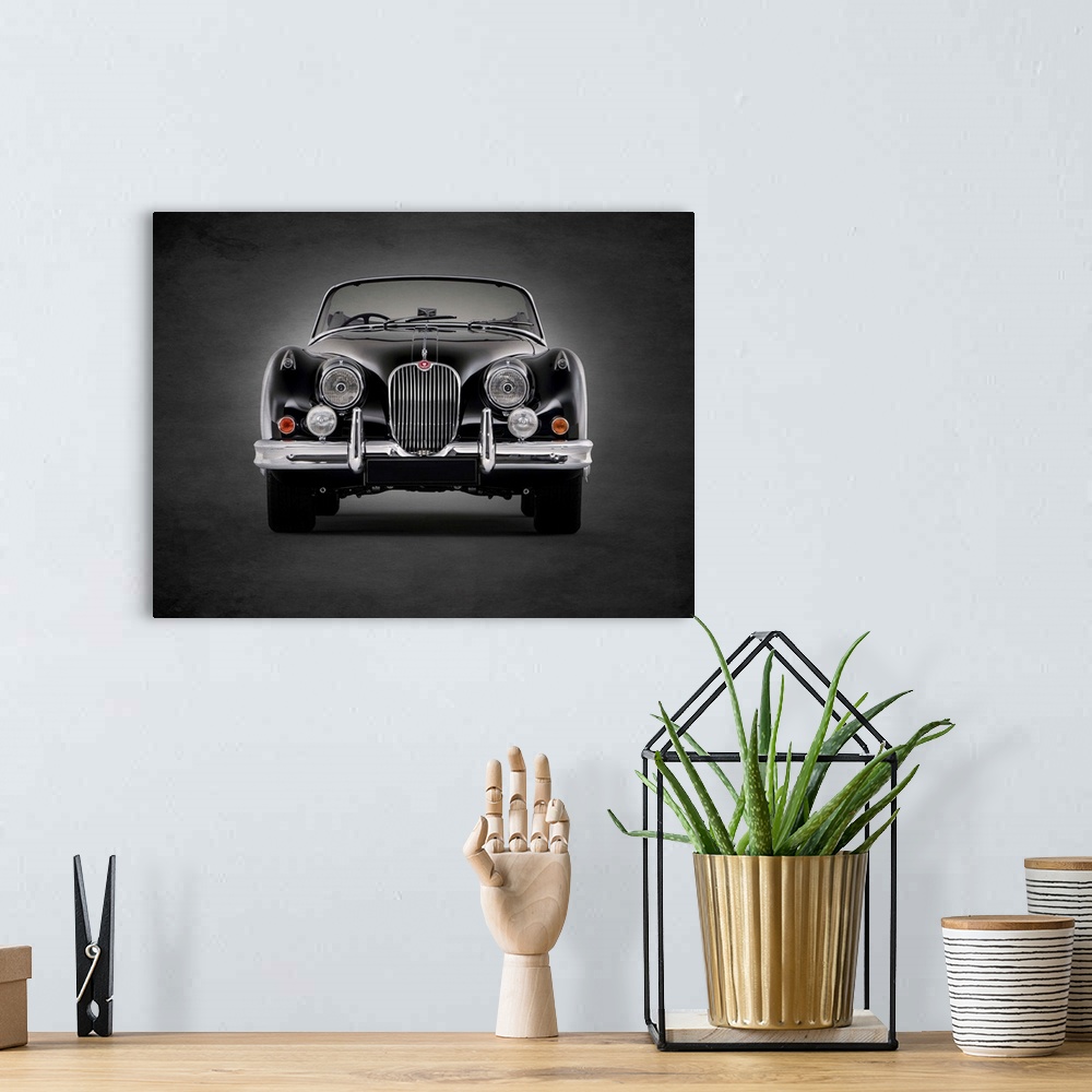 A bohemian room featuring Photograph of a black 1958 Jaguar XK150 printed on a black background with a dark vignette.