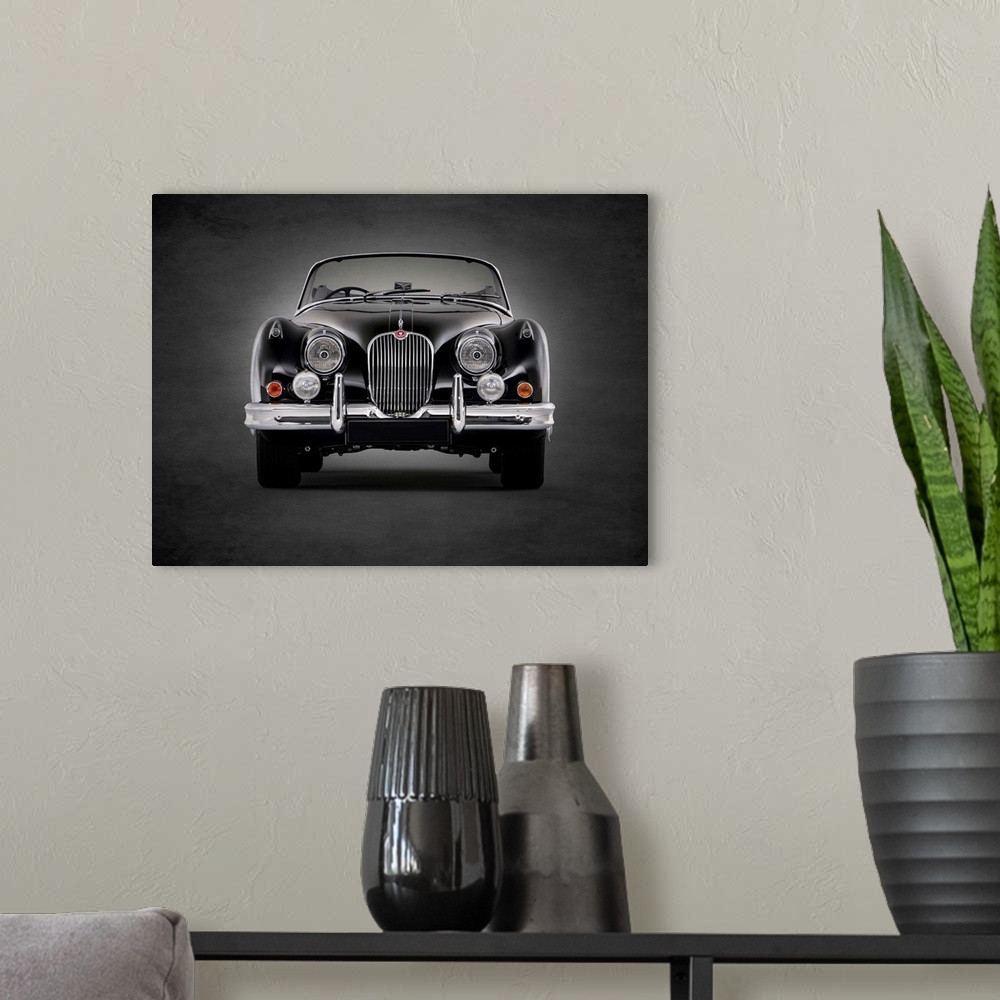 A modern room featuring Photograph of a black 1958 Jaguar XK150 printed on a black background with a dark vignette.