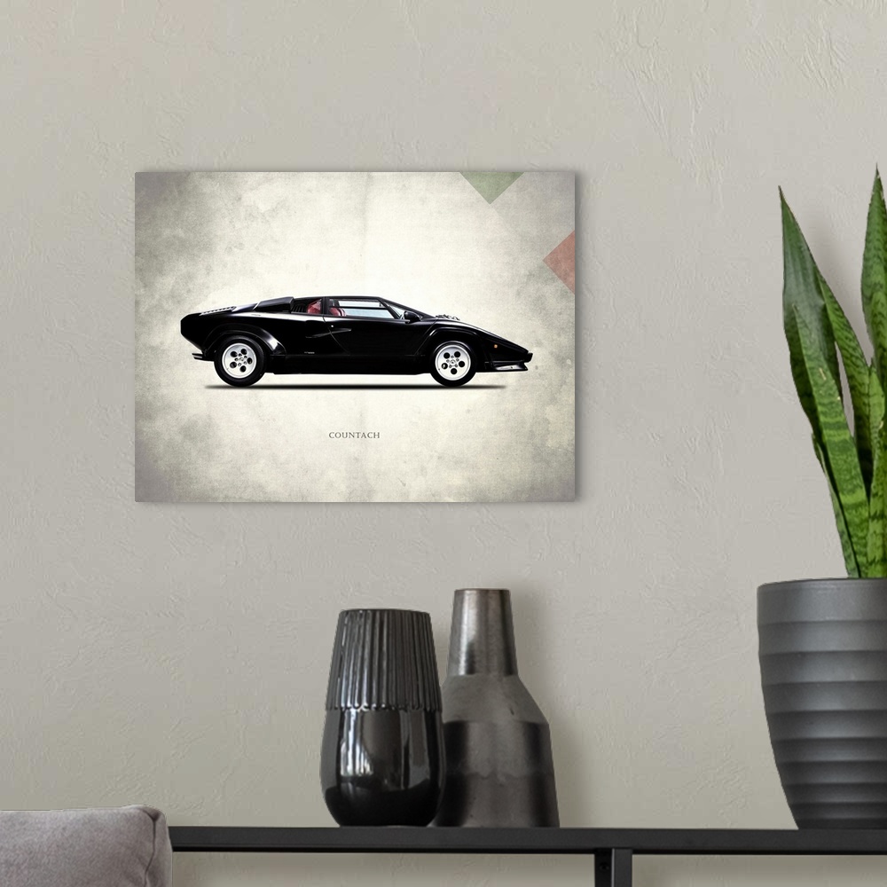 A modern room featuring Photograph of a black Lamborghini Countach 5000 printed on a distressed white and gray background...