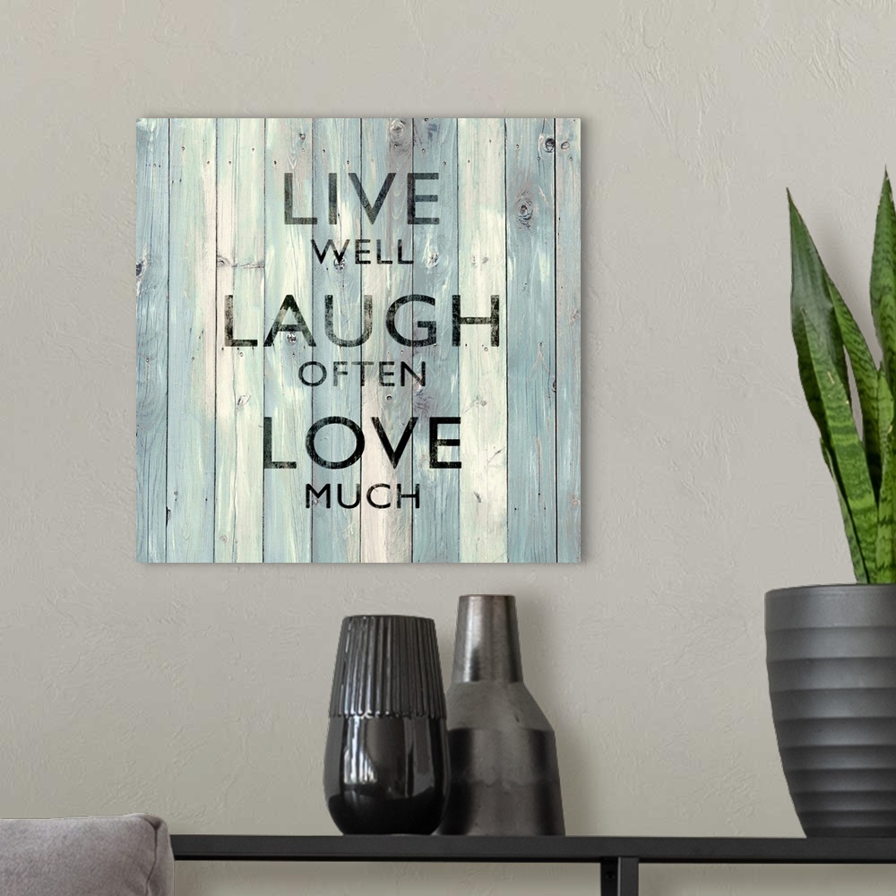 A modern room featuring "Live Well Laugh Often Love Much"