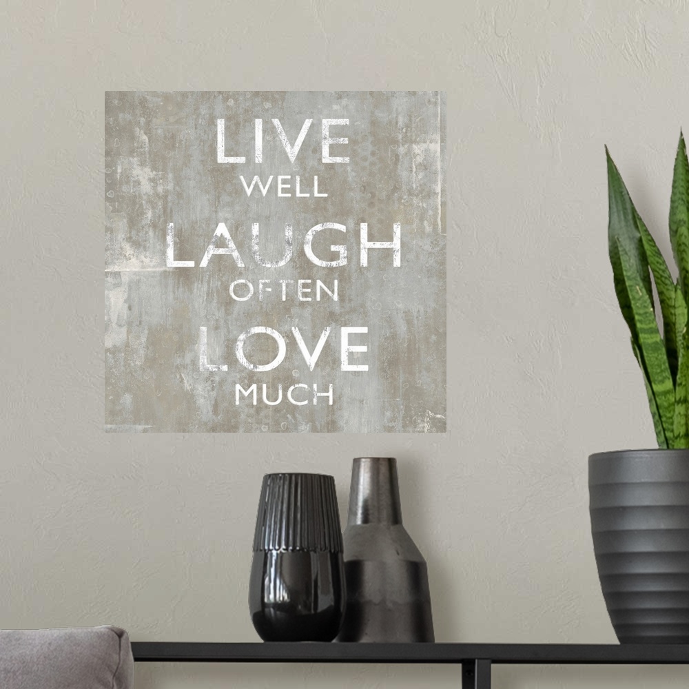 A modern room featuring "Live Well Laugh Often Love Much"