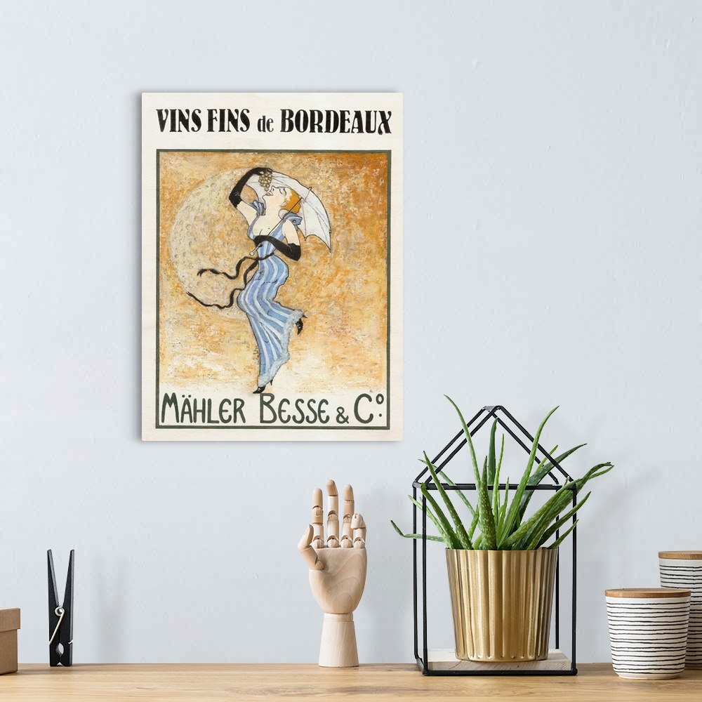 A bohemian room featuring French poster advertising wine with a woman carrying an umbrella and eating grapes with the moon ...