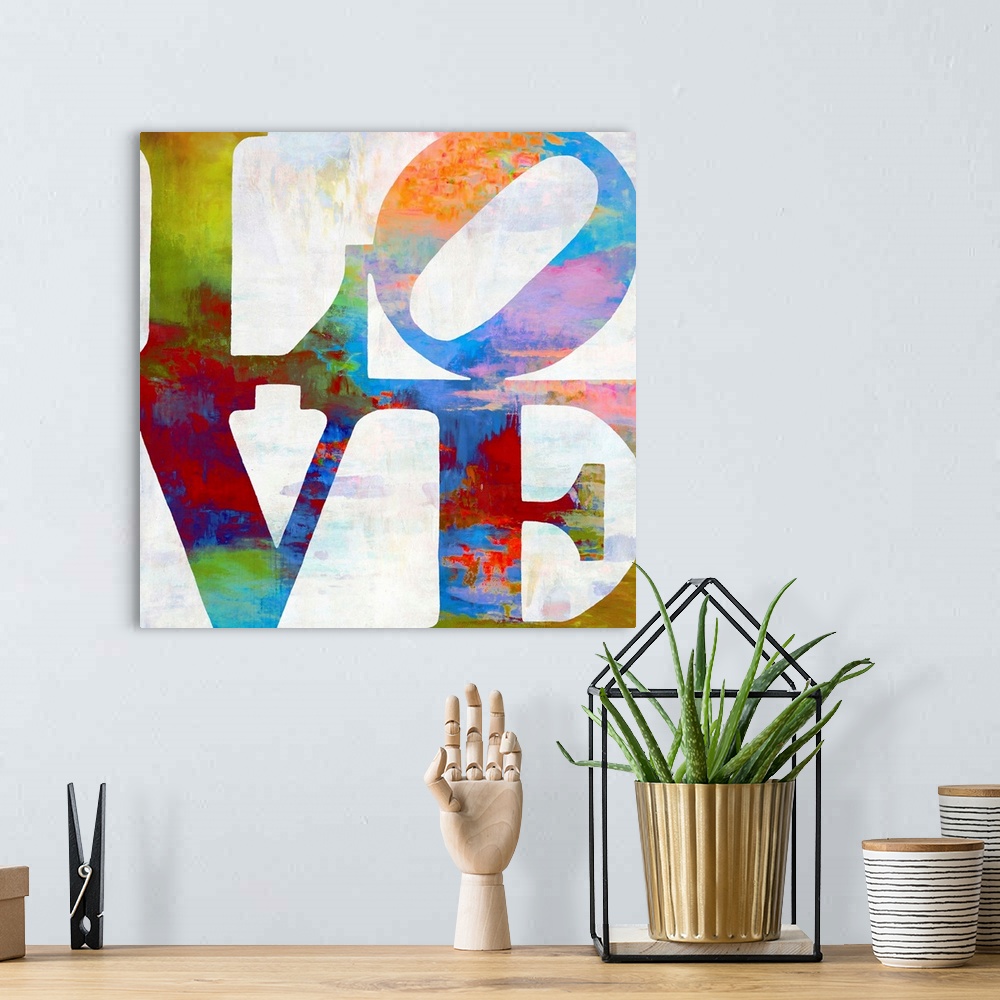 A bohemian room featuring "LOVE" written out in two lines in vibrant colors.