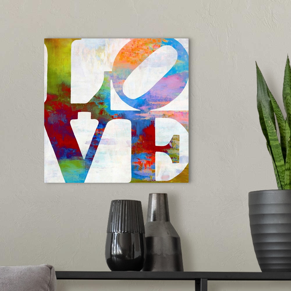 A modern room featuring "LOVE" written out in two lines in vibrant colors.