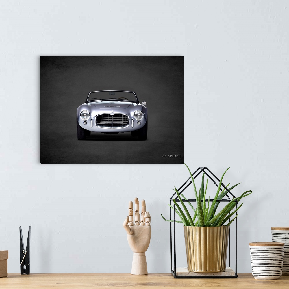 A bohemian room featuring Photograph of a silver Maserati A6 Spider printed on a black background with a dark vignette.