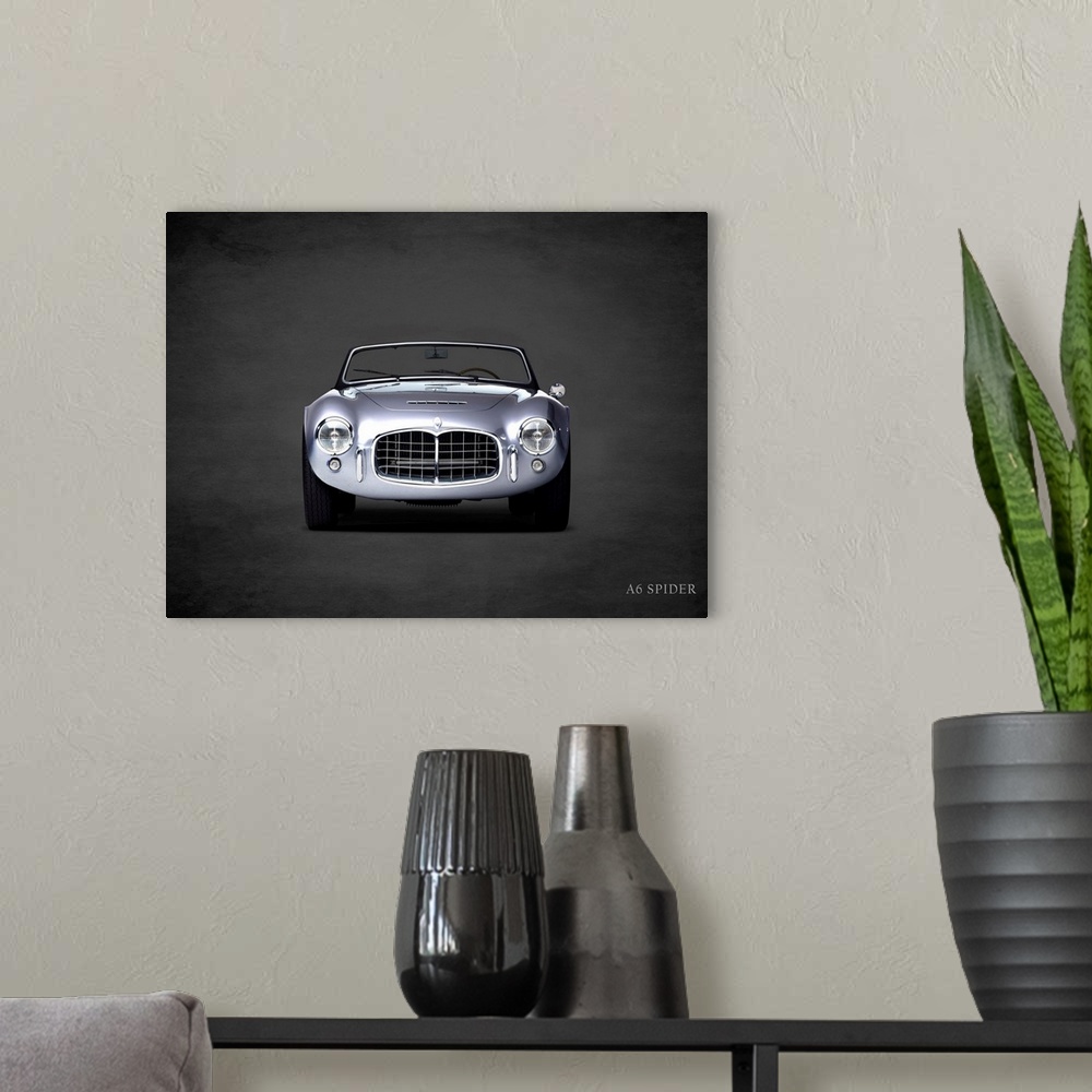 A modern room featuring Photograph of a silver Maserati A6 Spider printed on a black background with a dark vignette.