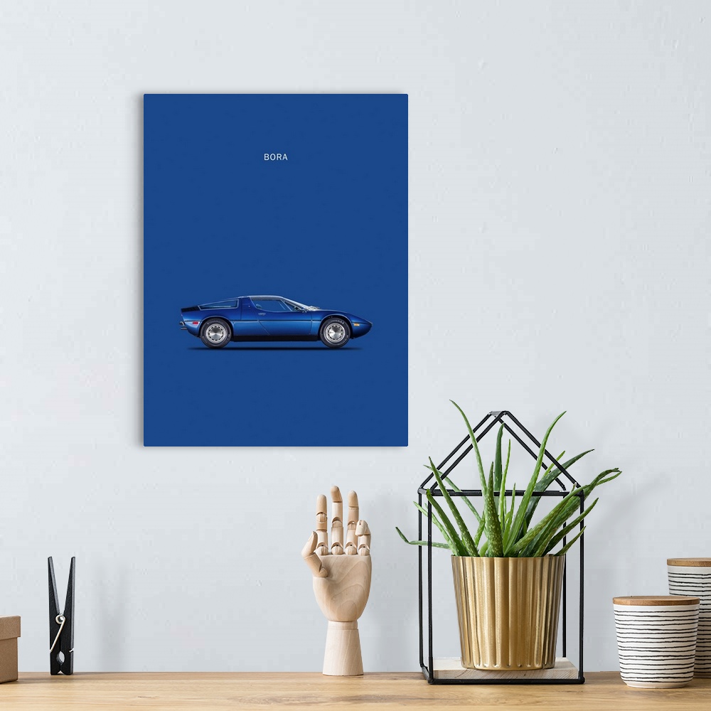 A bohemian room featuring Photograph of a blue Maserati Bora 1973 printed on a blue background