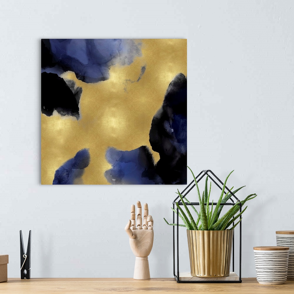 A bohemian room featuring Abstract painting with indigo hues splattered together on a gold background.