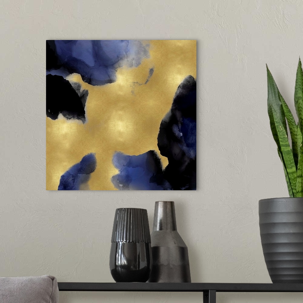 A modern room featuring Abstract painting with indigo hues splattered together on a gold background.